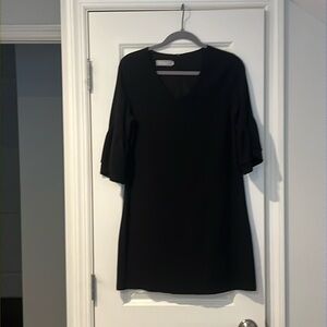 Black a-line dress with trumpet sleeves and back zip closure (size S)